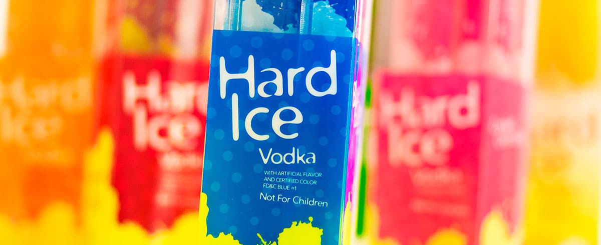Hard Ice Blue Raspberry Vodka Freezie in foreground.